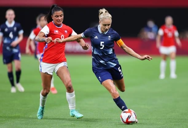 Steph Houghton of Team Great Britain is closed down by Jose Urrutia Maria of Team Chile during the Women's First Round Group E match between Great...