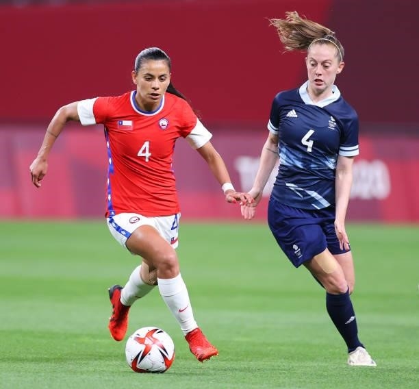 Francisca Lara of Team Chile runs with the ball whilst under pressure from Keira Walsh of Team Great Britain during the Women's First Round Group E...