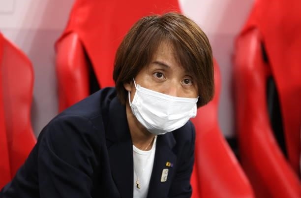 Asako Takakura, Head Coach of Team Japan wears a face mask prior to the Women's First Round Group E match between Japan and Canada during the Tokyo...