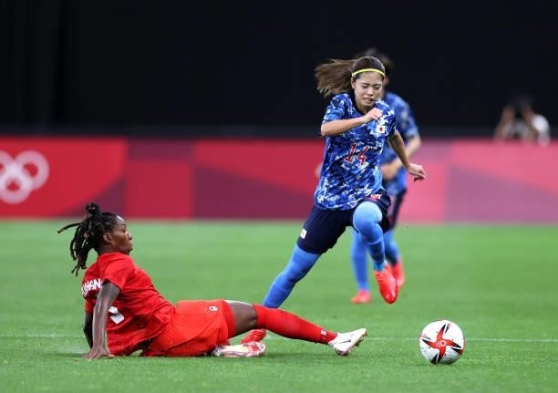 Yui Hasegawa of Team Japan breaks away from Kadeisha Buchanan of Team Canada during the Women's First Round Group E match between Japan and Canada...