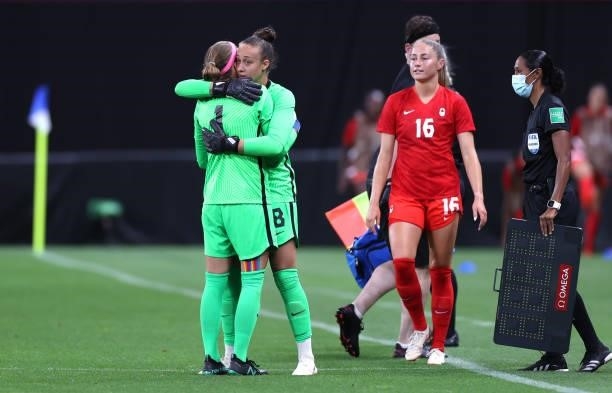 Stephanie Labbe of Team Canada is embraced by teammate Kailen Sheridan as she is substituted during the Women's First Round Group E match between...