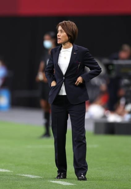 Asako Takakura, Head Coach of Team Japan looks on during the Women's First Round Group E match between Japan and Canada during the Tokyo 2020 Olympic...