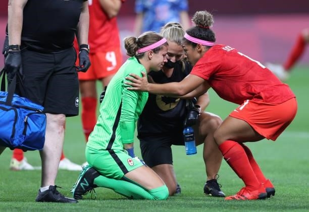 Stephanie Labbe of Team Canada reacts reacts as they receive medical treatment during the Women's First Round Group E match between Japan and Canada...