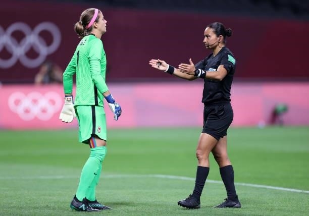 Match Referee, Edina Alves Batista speaks with Stephanie Labbe of Team Canada after awarding a penalty for Team Japan after a VAR review during the...