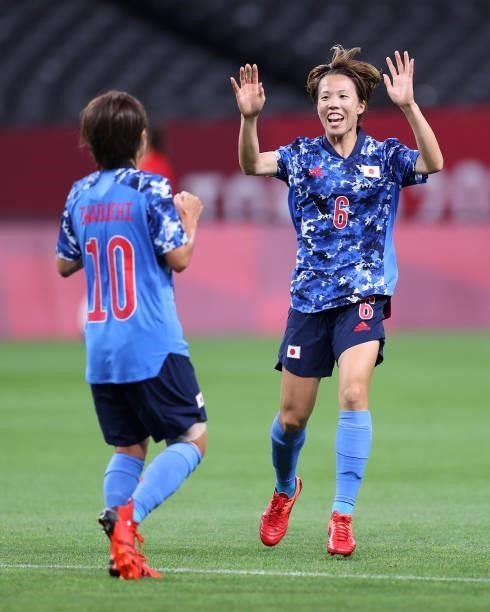 Mana Iwabuchi of Team Japan is congratulated by teammate Hina Sugita after scoring their side's first goal during the Women's First Round Group E...