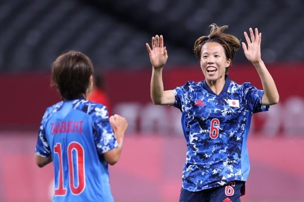 Mana Iwabuchi of Team Japan is congratulated by teammate Hina Sugita after scoring their side's first goal during the Women's First Round Group E...