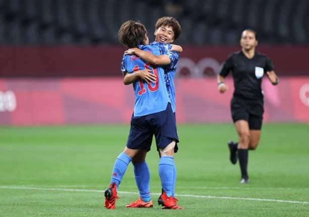 Mana Iwabuchi of Team Japan is congratulated by teammate Mina Tanaka after scoring their side's first goal during the Women's First Round Group E...