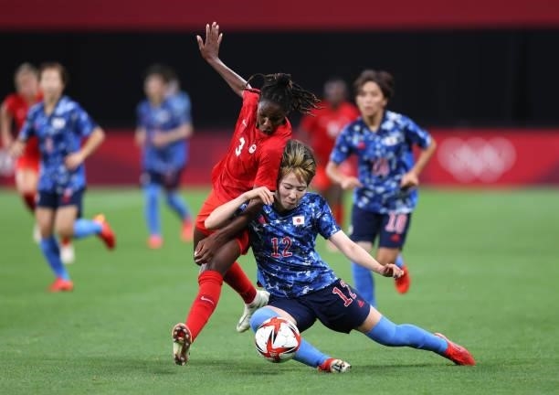 Jun Endo of Team Japan battles for possession with Kadeisha Buchanan of Team Canada during the Women's First Round Group E match between Japan and...