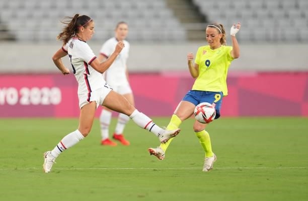 Alex Morgan of the United States battles with Kosovare Asllani of Sweden for a loose ball during a game between Sweden and USWNT at Tokyo Stadium on...