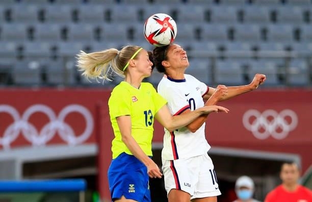 Carli Lloyd of the United States leaps high for a head ball during a game between Sweden and USWNT at Tokyo Stadium on July 21, 2021 in Tokyo, Japan.