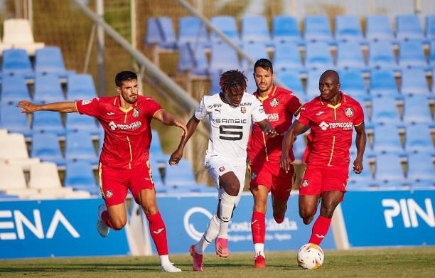 Victor Vitolo and Sabit Abdulai of Getafe competes for the ball with Loum Tchaouna of Stade Rennais during a Pre-Season friendly match between Getafe...