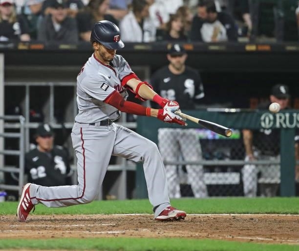 Andrelton Simmons of the Minnesota Twins hits a single in the 6th inning against the Chicago White Sox at Guaranteed Rate Field on July 21, 2021 in...