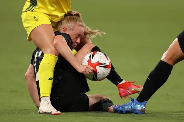 Betsy Hassett of New Zealand is tackled Ellie Carpenter of Australia in the Women's First Round Group G match during the Tokyo 2020 Olympic Games at...