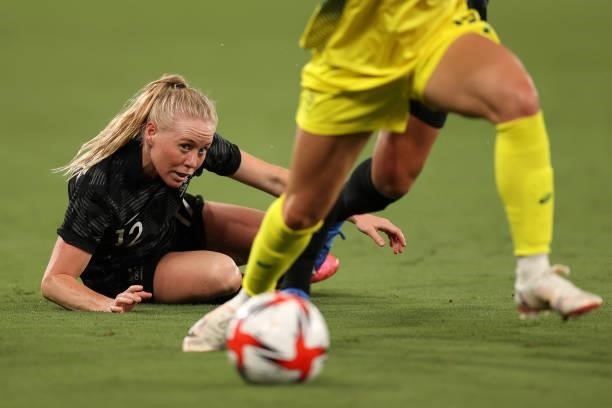 Betsy Hassett of New Zealand looses control of the ball to Ellie Carpenter of Australia in the Women's First Round Group G match during the Tokyo...