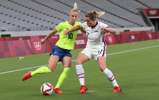 Sofia Jakobsson of Sweden vies with Abby Dehlkemper of United States is seen in the Women's First Round Group G match between Sweden and United...