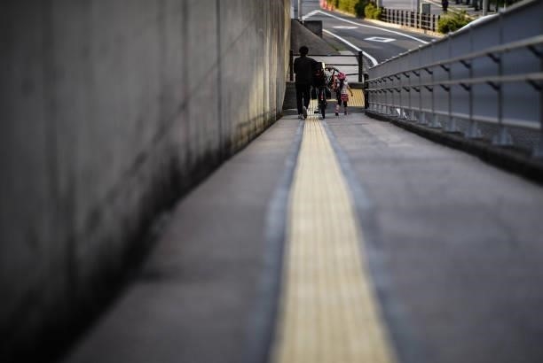 Mother walks down a walkway with her daughter near the Ariake Gymnastics Center ahead of the Tokyo 2020 Olympic Games on July 22, 2021 in Tokyo,...
