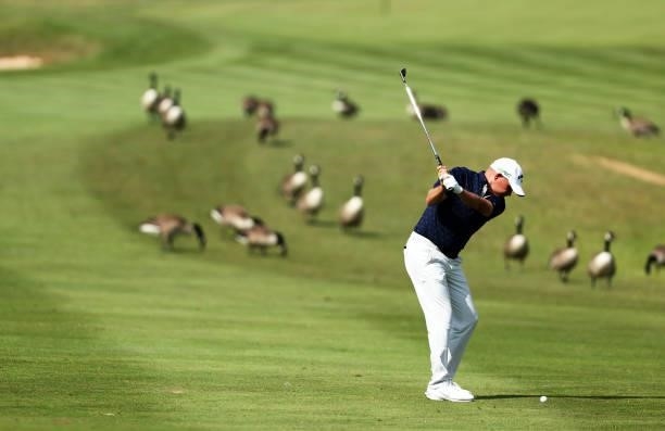 James Morrison of England plays his second shot on hole 6 as Geese are seen on the course during Day One of the Cazoo Open supported by Gareth Bale...