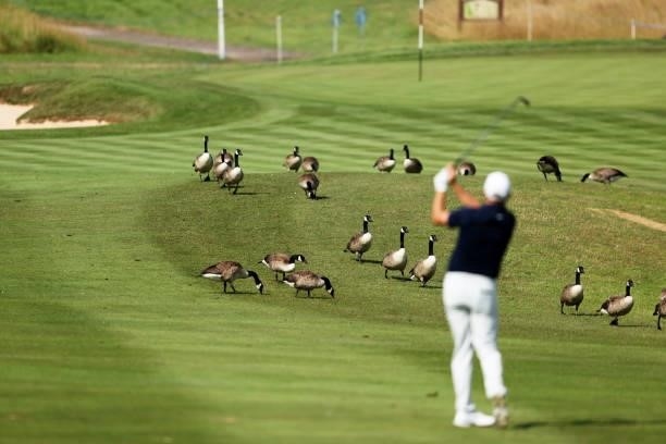James Morrison of England plays his second shot on hole 6 as Geese are seen on the course during Day One of the Cazoo Open supported by Gareth Bale...