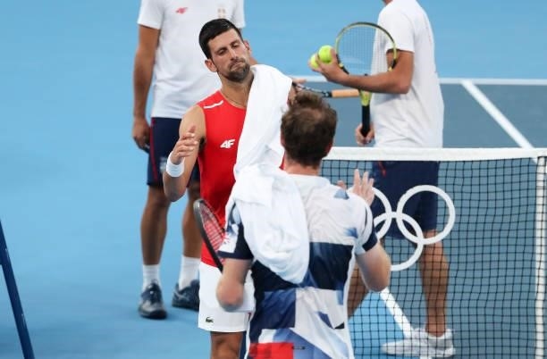 Novak Djokovic of Serbia shakes hands with Andy Murray of Great Britain after their practice ahead of the Tokyo 2020 Olympic Games at Ariake Tennis...