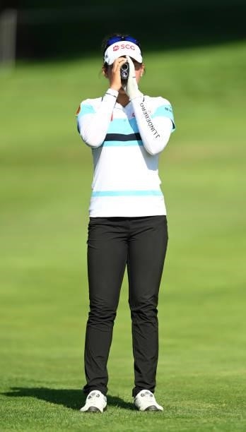 Atthaya Thitikul of Thailand checks the distance on hole 18 during day one of the The Amundi Evian Championship at Evian Resort Golf Club on July 22,...