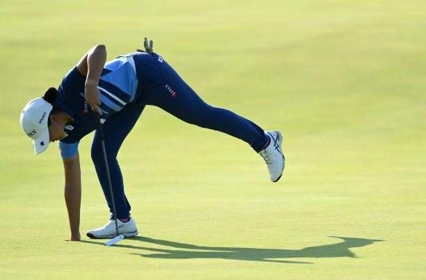 Tsubasa Kajitani of Japan retrieves her ball from hole 18 during day one of the The Amundi Evian Championship at Evian Resort Golf Club on July 22,...