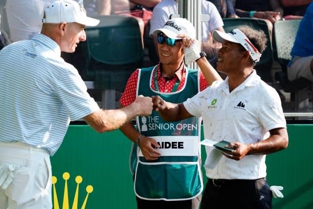 Jim Furyk of United States knuckles Thongchai Jaidee of Thailand during the first round of the Senior Open presented by Rolex at Sunningdale Golf...