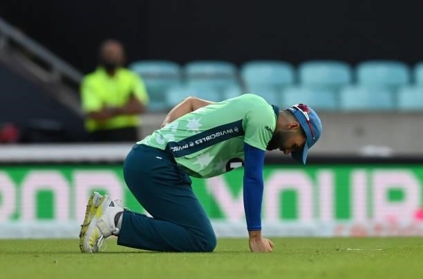 Saqib Mahmood of Oval Invincibles picks up an injury during the Hundred match between Oval Invincibles and Manchester Originals at The Kia Oval on...