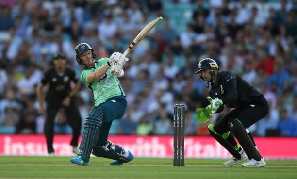 Sam Billings of Oval Invincibles bats watched by Manchester Originals wicketkeeper Jos Buttler during the Hundred match between Oval Invincibles and...