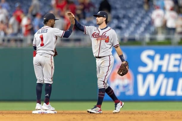 Dansby Swanson of the Atlanta Braves celebrates with Ozzie Albies against the Philadelphia Phillies at Citizens Bank Park on July 22, 2021 in...