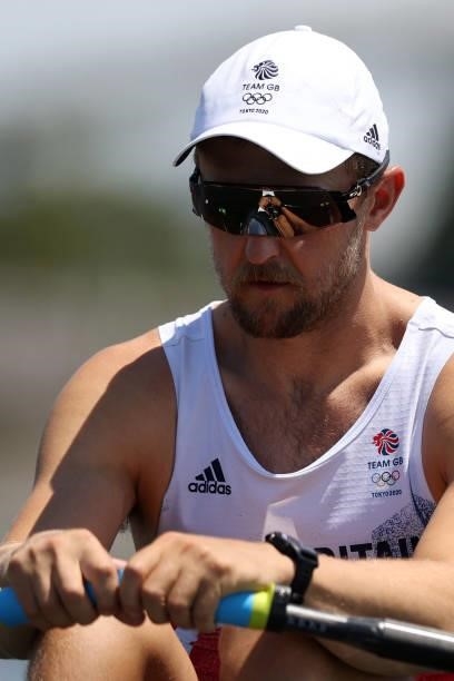 John Collins of Team Great Britain looks on at the start line as the reflection of his hands is seen in his sunglasses before he competes in the...