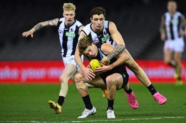 Xavier Duursma of the Power is tackled by Trey Ruscoe of the Magpies during the round 19 AFL match between Port Adelaide Power and Collingwood...