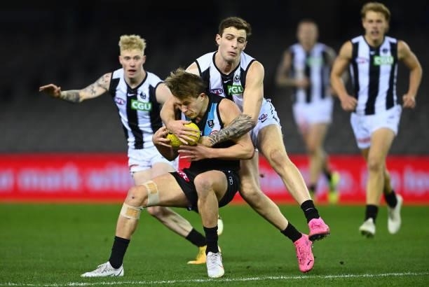 Xavier Duursma of the Power is tackled by Trey Ruscoe of the Magpies during the round 19 AFL match between Port Adelaide Power and Collingwood...