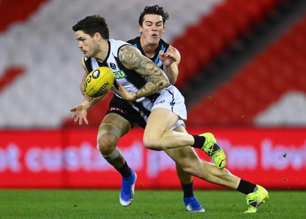 Jack Crisp of the Magpies is tackled by Connor Rozee of the Power during the round 19 AFL match between Port Adelaide Power and Collingwood Magpies...