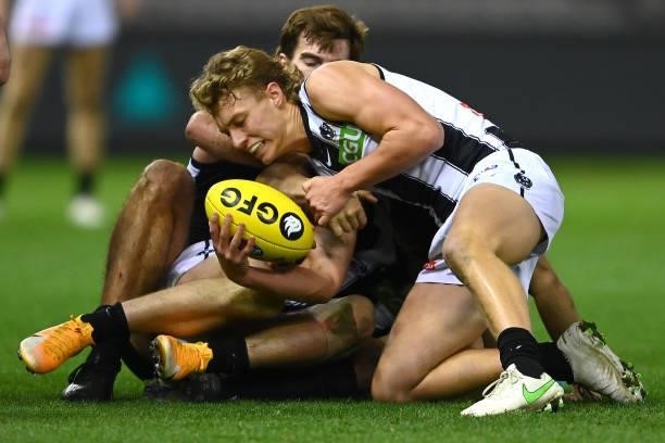 Finlay Macrae of the Magpies is tackled during the round 19 AFL match between Port Adelaide Power and Collingwood Magpies at Marvel Stadium on July...