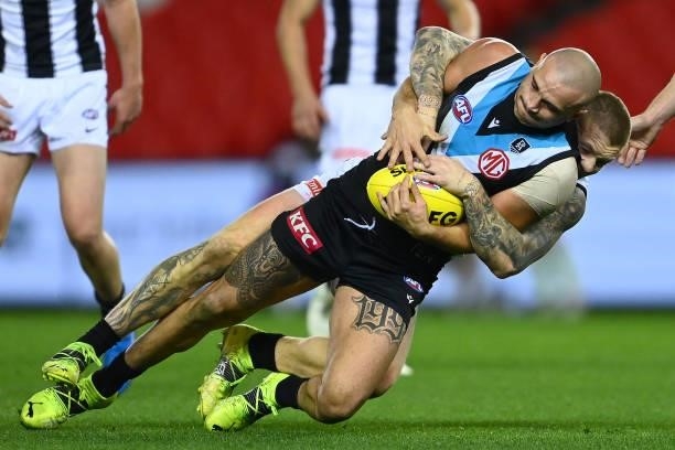 Sam Powell-Pepper of the Power is tackled by Jordan De Goey of the Magpies during the round 19 AFL match between Port Adelaide Power and Collingwood...