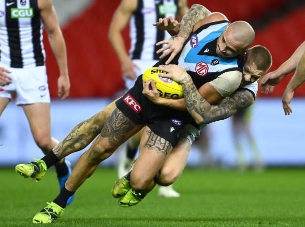 Sam Powell-Pepper of the Power is tackled by Jordan De Goey of the Magpies during the round 19 AFL match between Port Adelaide Power and Collingwood...