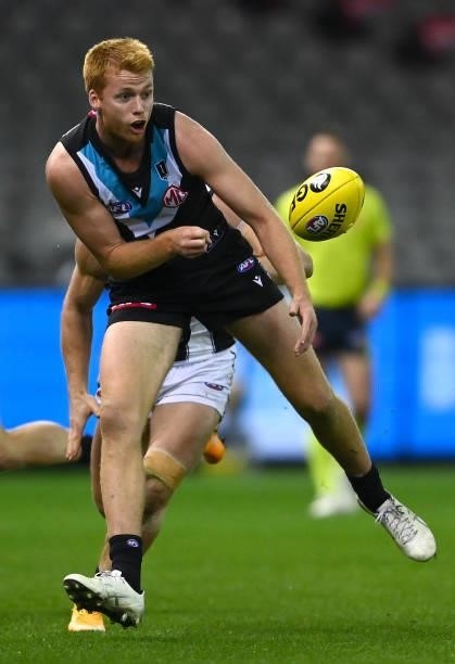 Willem Drew of the Power handballs whilst being tackled during the round 19 AFL match between Port Adelaide Power and Collingwood Magpies at Marvel...