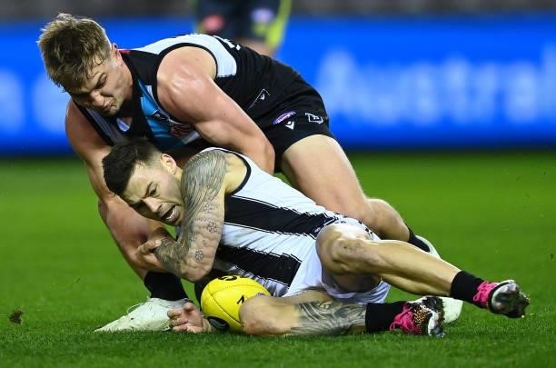 Ollie Wines of the Power and Jamie Elliott of the Magpies compete for the ball during the round 19 AFL match between Port Adelaide Power and...