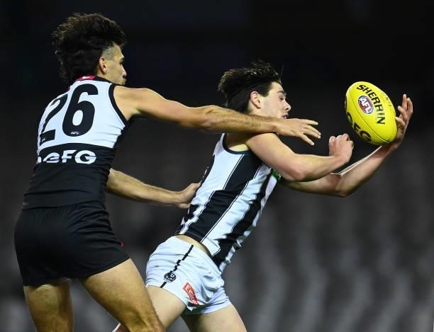 Oliver Henry of the Magpies marks infront of Riley Bonner of the Power during the round 19 AFL match between Port Adelaide Power and Collingwood...