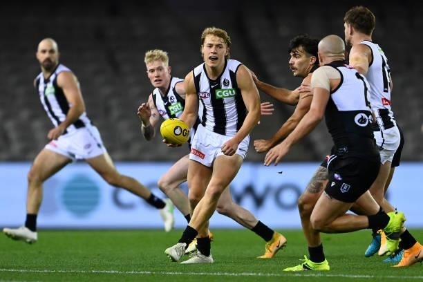 Finlay Macrae of the Magpies handballs during the round 19 AFL match between Port Adelaide Power and Collingwood Magpies at Marvel Stadium on July...