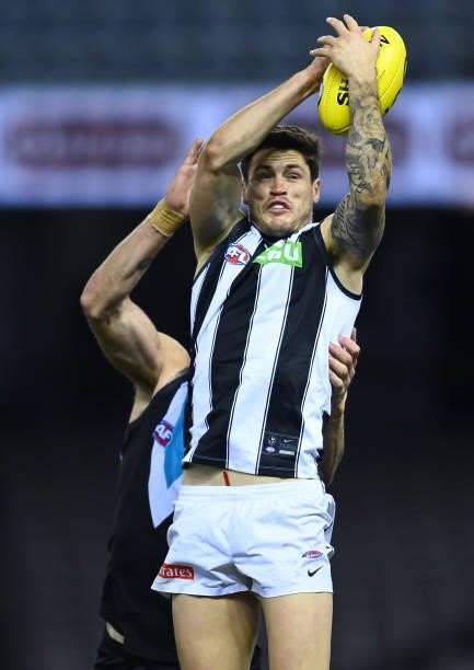 Jack Crisp of the Magpies marks during the round 19 AFL match between Port Adelaide Power and Collingwood Magpies at Marvel Stadium on July 23, 2021...