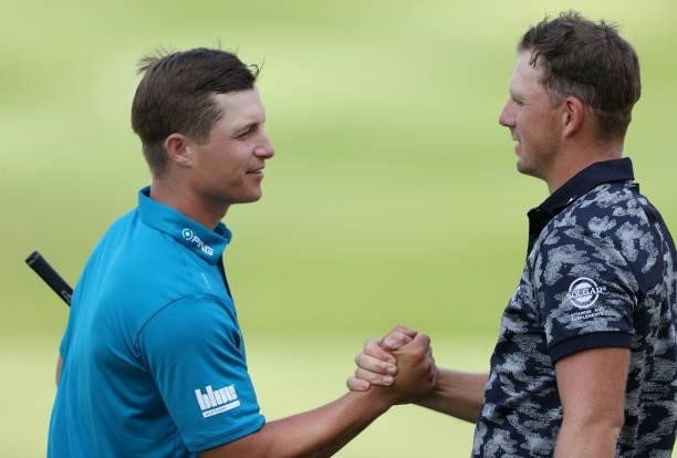 Matt Wallace of England and Calum Hill of Scotland interact after finishing their round on the 18th green during Day Two of the Cazoo Open supported...
