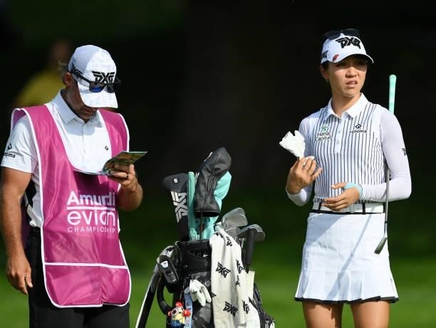 Lydia Ko of New Zealand looks on with their caddie on the 18th hole during day two of the The Amundi Evian Championship at Evian Resort Golf Club on...