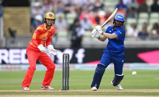 Deepti Sharma of London Spirit bats watched by Birmingham Phoenix wicketkeeper Amy Jones during The Hundred match between Birmingham Phoenix and...
