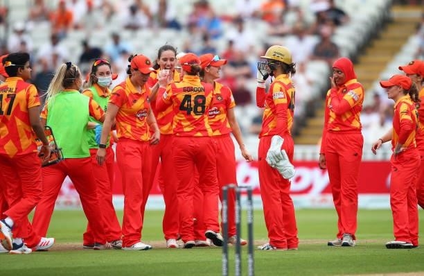 Emily Arlott of Birmingham Phoenix celebrates with her teammates after dismissing Susie Rowe of London Spirit during The Hundred game between...