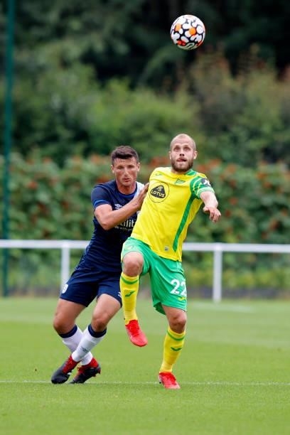 Matty Pearson of Huddersfield Town battles with Teemu Pukki of Norwich City during the game between Norwich City and Huddersfield Town on July 23,...