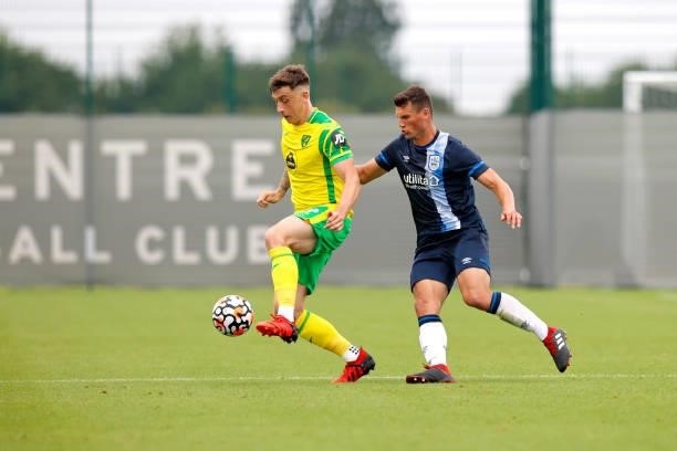 Matty Pearson of Huddersfield Town challenges Jordan Hugill of Norwich City during the game between Norwich City and Huddersfield Town on July 23,...