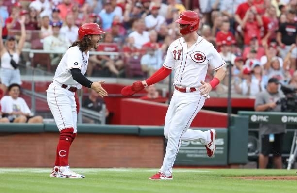 Tyler Stephenson of the Cincinnati Reds is congratulated by Jonathan India after they both scored in the first inning against the St. Louis Cardinals...