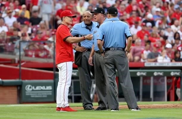 David Bell the manager of the Cincinnati Reds talks with the umpires in the second inning against the St. Louis Cardinals at Great American Ball Park...