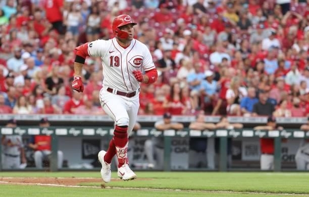 Joey Votto of the Cincinnati Reds runs to first base after hitting a single in the third inning against the St. Louis Cardinals at Great American...